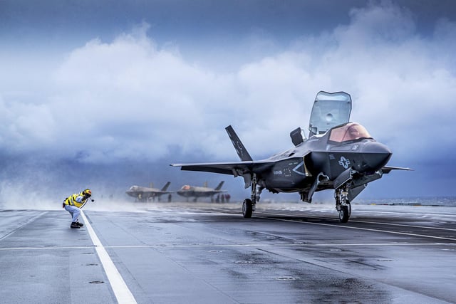 A USMC F35-B taking off.
HMS Queen Elizabeth has embarked two squadrons of F-35B stealth jets: the UK’s 617 Sqn and US Marine Corps fighter attack squadron 211.
With a total of fifteen F-35B’s and eight Merlin helicopters, it’s the largest air group to operate from a Royal Navy carrier in more than thirty years, and the largest air group of fifth generation fighters at sea anywhere in the world.
This month’s Group Exercise (GROUPEX) will see HMS Queen Elizabeth joined by warships from the UK, US and the Netherlands, which will accompany HMS Queen Elizabeth on her first global deployment in 2121.
However before then, the newly formed Carrier Strike Group will be put through its paces off the North East coast of Scotland as part of Joint Warrior, NATO’s largest annual exercise.