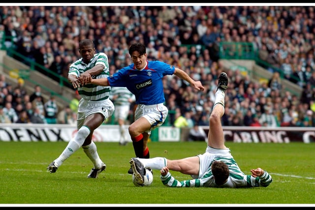 Celtic v Rangers in 2004- Chris Sutton (right) defends as Michael Mols (Rangers) tries to break through, with Bobo Balde (left) also looking to check the run - Celtic won 3-0