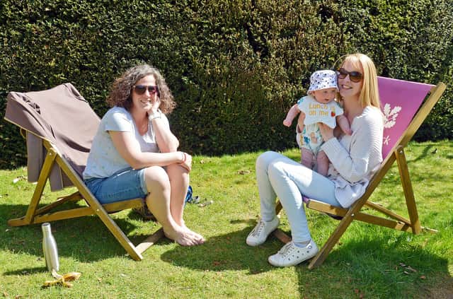 Hardwick Hall in spring bloom. Lorna Martin and Sophie and Harriet Hardstaff enjoying the spring sun in the South Lawn.