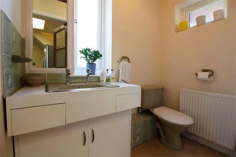 Comprising low-level WC and wash hand basin with vanity unit. Front and side-aspect windows.