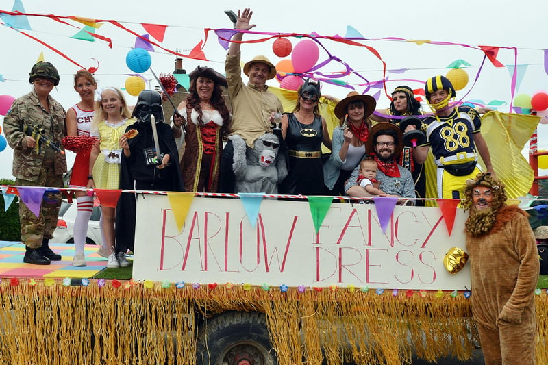 The sign on this float says it all!  Spot anyone you know among the fancy dress crew?