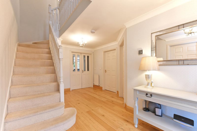 The entrance hall has a coved ceiling, pendant light points, central heating radiator, telephone point and oak flooring. Timber doors open to the WC, snug and lounge. A set of double doors with glazed panels open to the dining kitchen.