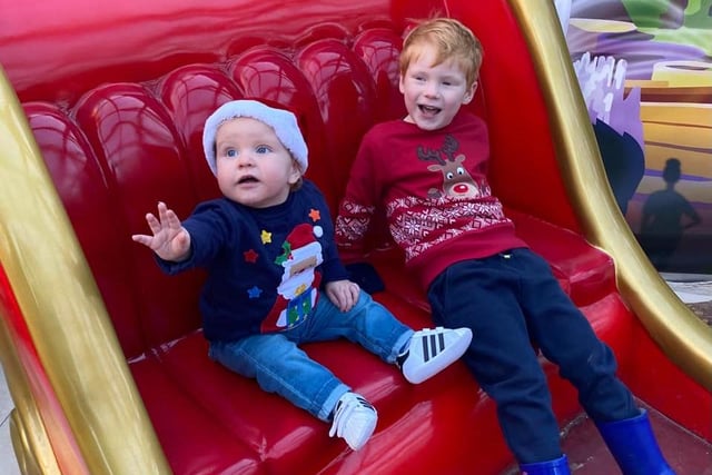George getting into some mischief on Santa's sleigh with cousin Jay.