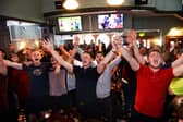 Blades fans celebrate in the Clubhouse, London Road after their side were promoted to the Premier League