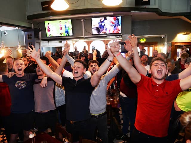 Blades fans celebrate in the Clubhouse, London Road after their side were promoted to the Premier League