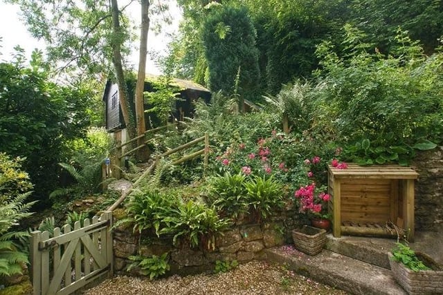 The detached cottage at Dale Road, Matlock, is surrounded by idyllic gardens and woodland and is set within a large hillside plot with exceptional views of the countryside.