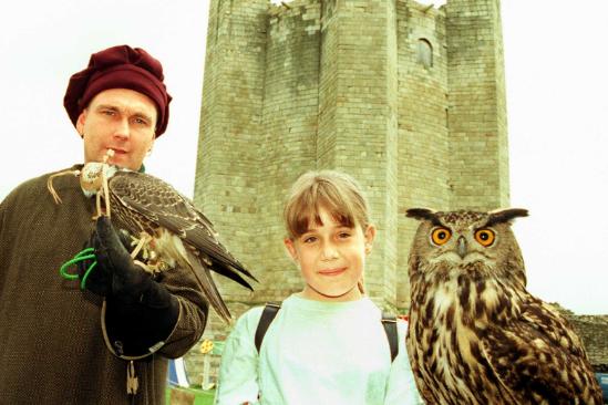 The castle would often have bird shows - here is Carl Hodgson in 1998 with visitor Samantha Stevenson holding an owl.