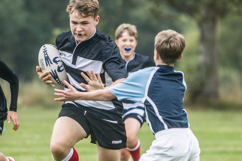 Kelso's Charlie Arnold holding off an opposition defender at Earlston's youth rugby festival