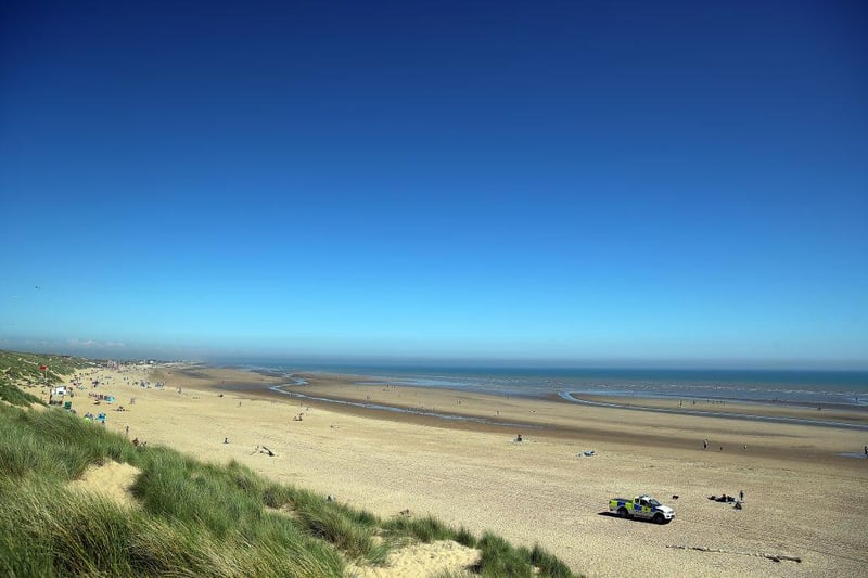 Holiday caravans, homes and cafes are close to the edge at Camber Sands, which is another area at high risk of coastal erosion - with the entire area possibly underwater in the next century.