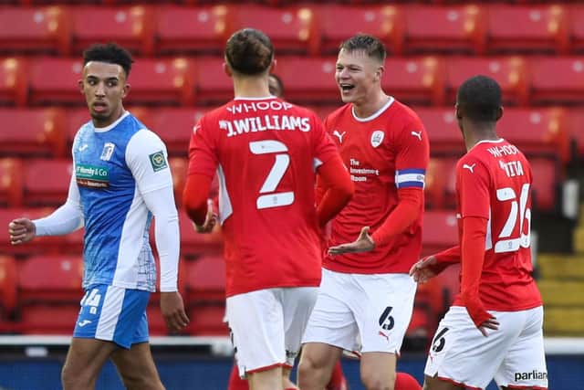 Barnsley's Mads Andersen (second right) celebrates scoring their side's first goal of the game during the Emirates FA Cup third round match against Barrow at Oakwell. Isaac Parkin/PA Wire.