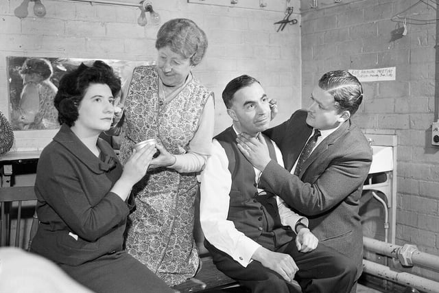 The Chamberlain Players North Morningside Church Dramatic Club help each other with their makeup backstage before a performance of 'The Testimonial' in May 1963.