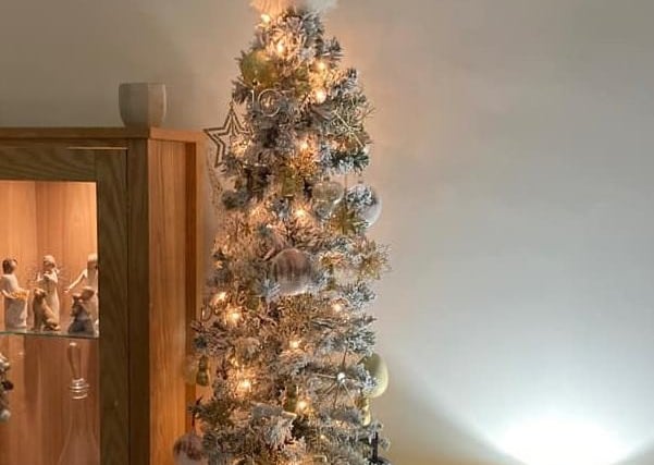 The decorations on Dawn Roberts' tall, slender tree blend in with the decor of the room.