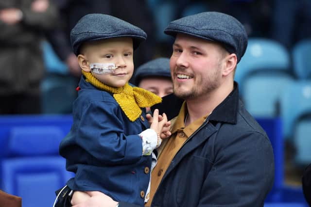 Former Sheffield Wednesday goalkeeper Arron Jameson with his son Jude on the pitch at Hillsborough.