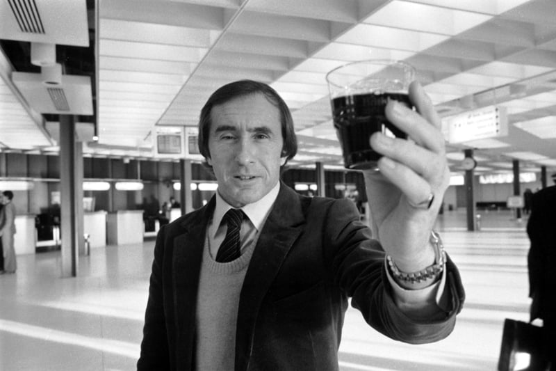 Scottish racing driver Jackie Stewart with a glass of the Beaujolais Nouveau wine flown in to Edinburgh airport in November 1983.
