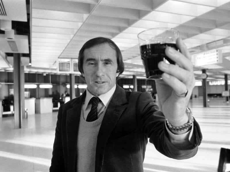 Scottish racing driver Jackie Stewart with a glass of the Beaujolais Nouveau wine flown in to Edinburgh airport in November 1983.