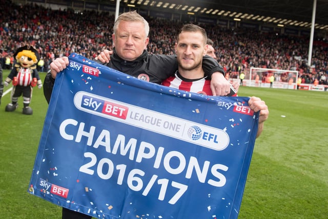 Wilder and legendary Blades striker Billy Sharp celebrate winning the Sky Bet League One title in April 2017.