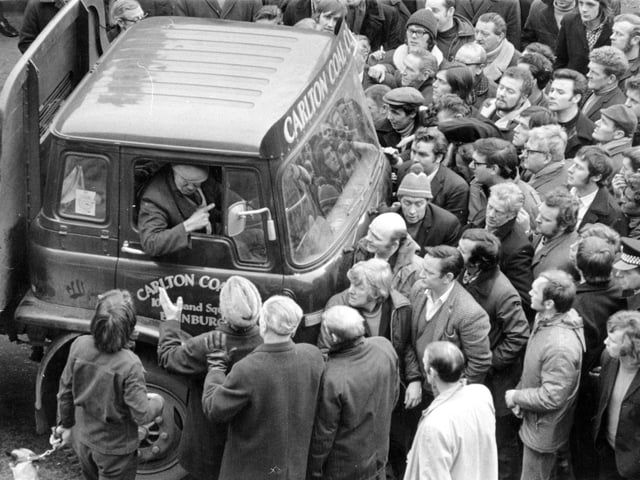 Pickets mob the driver of a lorry collecting coal from Haymarket  depot.