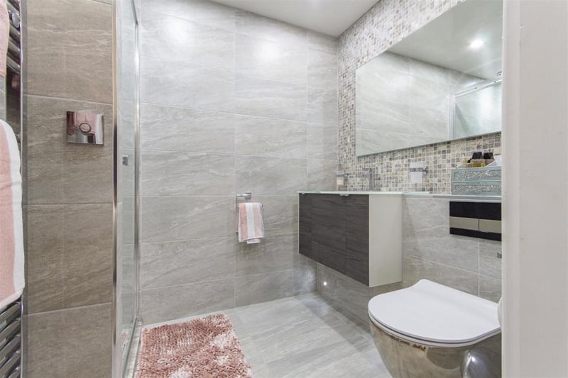 The ensuite shower room, off bedroom two, features a contemporary, white, three-piece suite comprising of a shower cubicle with digital mixer shower, wall-hung wash hand basin with storage below and a low-flush WC.