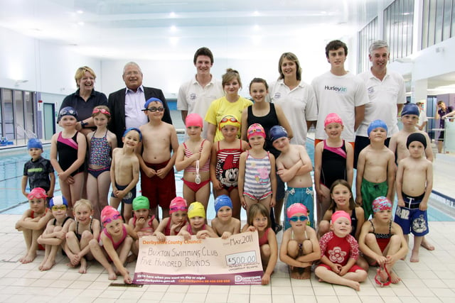 Cllr Robin Baldrey (back row) was on hand to present a cheque for £500 to the members and coaches of Buxton Swimming Club.