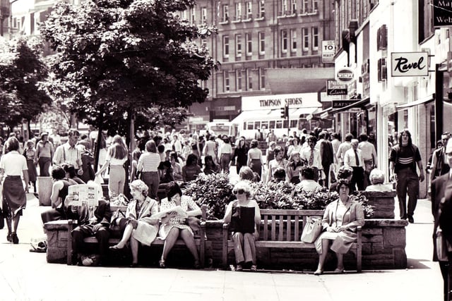 People relaxing in the sun in Fargate, Sheffield