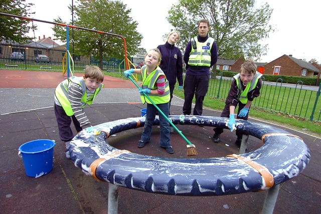 Cleaning the play equipment next to the Wheatley Park Youth Centre in 2011 were  from left, Kai Daniels-Maxfield, aged nine, Jamie-Leigh Daniels-Maxfield, aged eight, and Caiden Cooley, aged 12. Looking on are Fay Larkins, Doncaster Council area officer, and PCSO Michael Kemble.