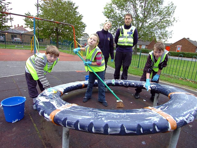 Cleaning the play equipment next to the Wheatley Park Youth Centre in 2011 were from left, Kai Daniels-Maxfield, aged nine, Jamie-Leigh Daniels-Maxfield, aged eight, and Caiden Cooley, aged 12. Looking on are Fay Larkins, Doncaster Council area officer, and PCSO Michael Kemble.