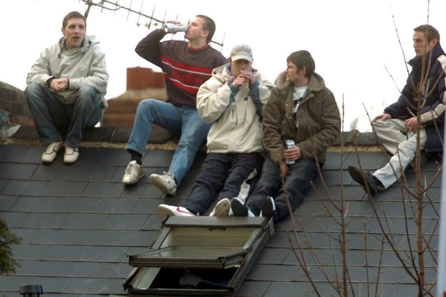 Blues fans without a ticket for the Owls game take to the roof.
