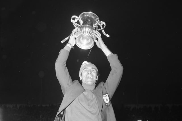 A famous scene as Bob Stokoe holds the FA Cup high for fans at Roker Park.