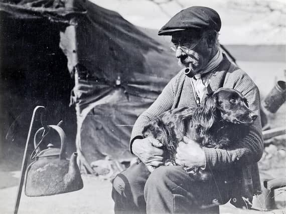 A man and his dog waiting for the kettle to boil.