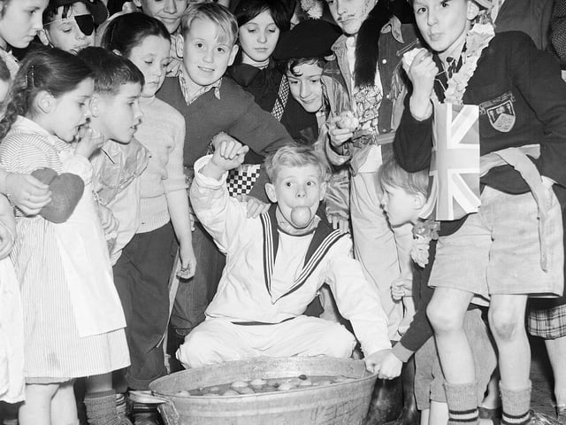 Tweedie Memorial Boys Club hold  their Halloween party at the West Port, Edinburgh. Boys dooking for apples.