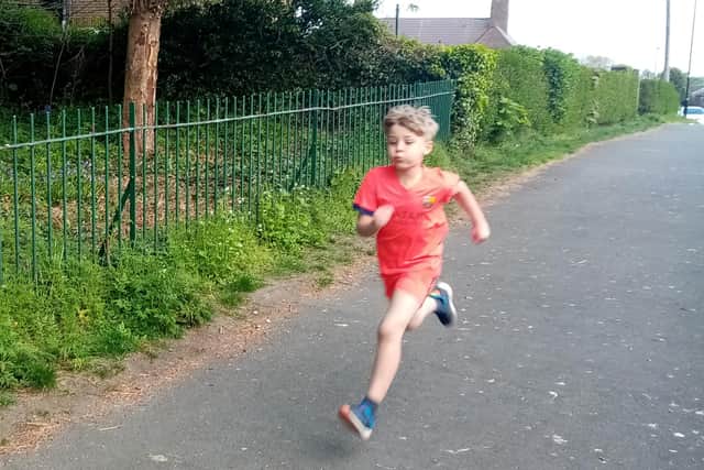 James Urwin, 8, is running to raise money for the NHS