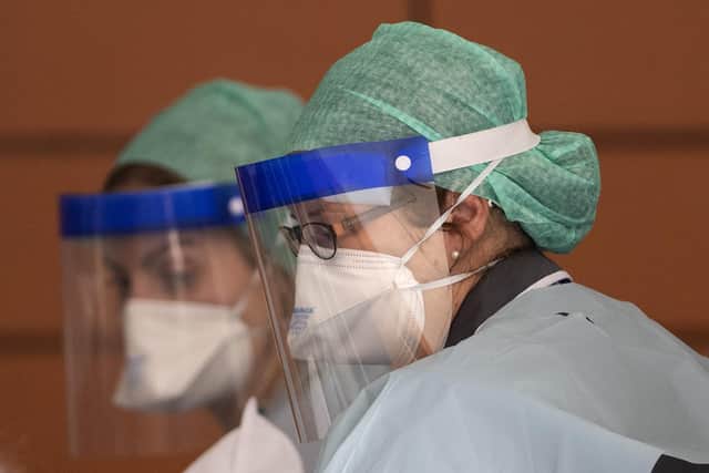 NHS workers in PPE attend to a patient at St Thomas' Hospital on April 10, 2020 in London, England (photo by Justin Setterfield/Getty Images).