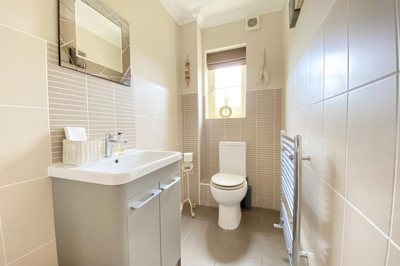 Solid oak door with chrome effect handle. Frosted double-glazed window to the rear, extractor fan, coved ceiling, tiled floor and surround, ladder radiator, modern pedestal wash hand basin with mixer tap and store cupboard under and a low-level flush WC.