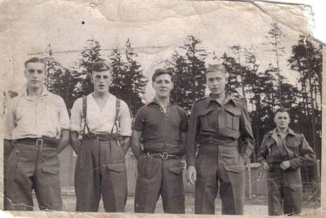Jack Kelly (centre) pictured with fellow prisoners-of-war