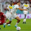 Senegal's forward #13 Iliman Ndiaye (R) and Qatar's midfielder #23 Assim Madibo fight for the ball during the Qatar 2022 World Cup Group A football match between Qatar and Senegal at the Al-Thumama Stadium in Doha on November 25, 2022. (Photo by Odd ANDERSEN / AFP) (Photo by ODD ANDERSEN/AFP via Getty Images)