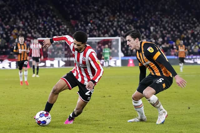 Sheffield United's Iliman Ndiaye (left) and Hull City's Alfie Jones battle for the ball during the Sky Bet Championship match at Bramall Lane: Danny Lawson/PA Wire.