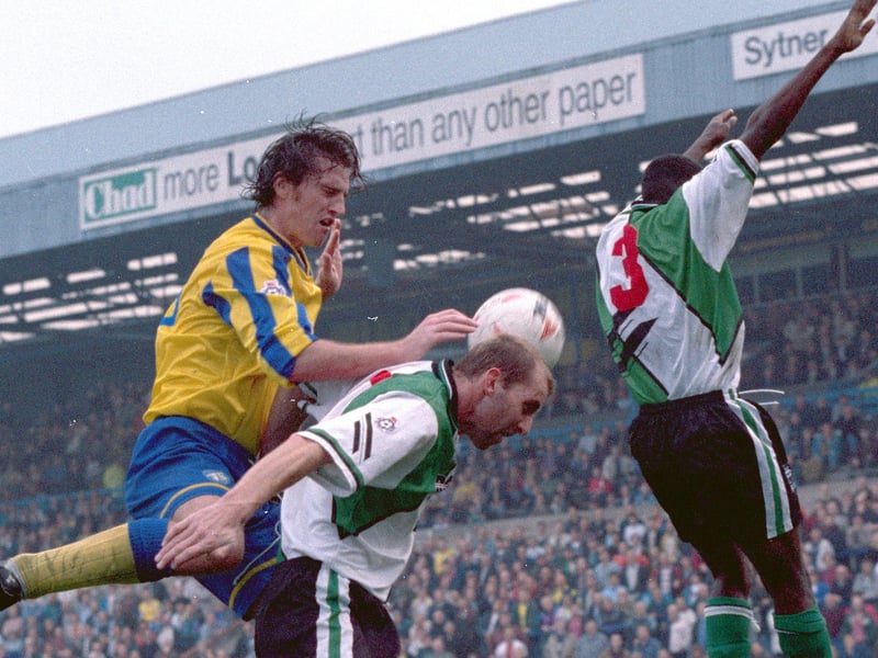 Lee Howarth jumps highest in front of the old West Stand against Plymouth Argyle.