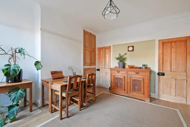 "Original built in floor to ceiling cupboards with stripped and stained door fronts," says the brochure. "Ceiling coving, picture rail and central heating radiator. A door with stairs beyond gives access down to the cellar room."