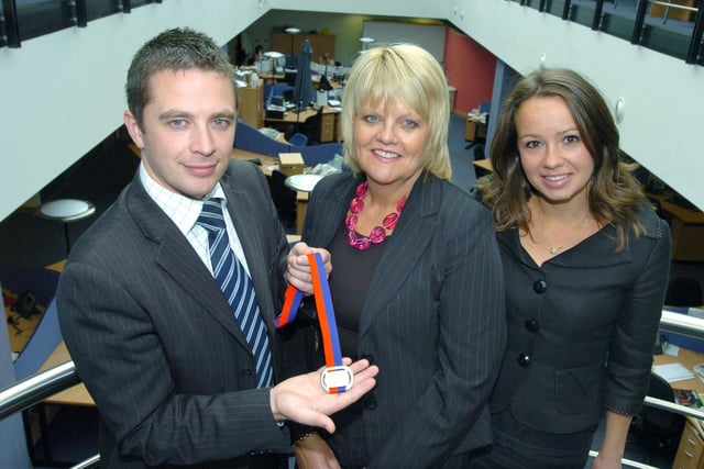 Lorraine Norcliffe, centre, received the Medal of Merit from Glyn Jones, Sheff Chamber of Commerce, with right, Nicky Brind, Sales Manager Kenwood Hall in 2009