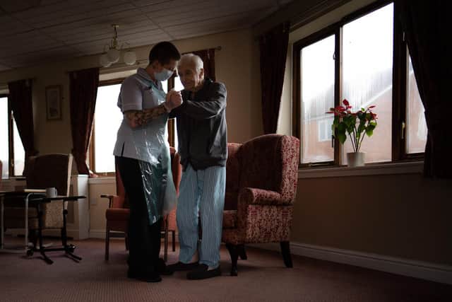 Jack Dodsley, 79, with a carer in PPE at Newfield Nursing Home, Sheffield
