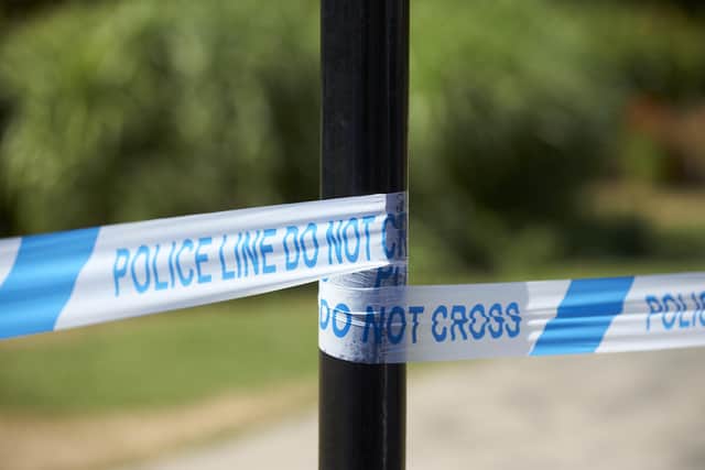 A cordon of police tape (Photo by Niklas HALLE'N / AFP) (Photo by NIKLAS HALLE'N/AFP via Getty Images)