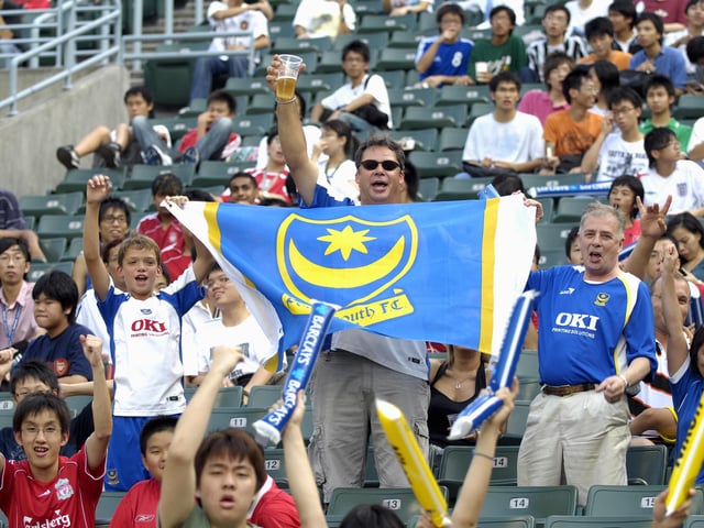 These Pompey fans soak up the atmosphere in the Hong Kong Stadium ahead of Pompey's game against Liverpool.
PICTURE: WILL CADDY (HK04-13)