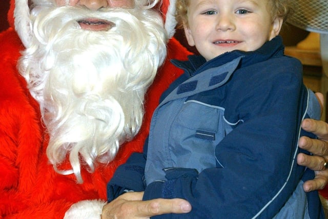 Father Christmas ( Neville Dawson) with 3 year old Rhys Morgan from Attercliffe in Santa's Grotto, Castle Co-op, Angel Street, Sheffield.