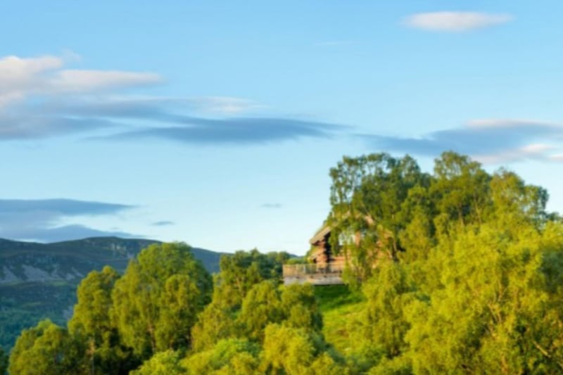 The cabins are set on the side of a hill overlooking a stunning glen.