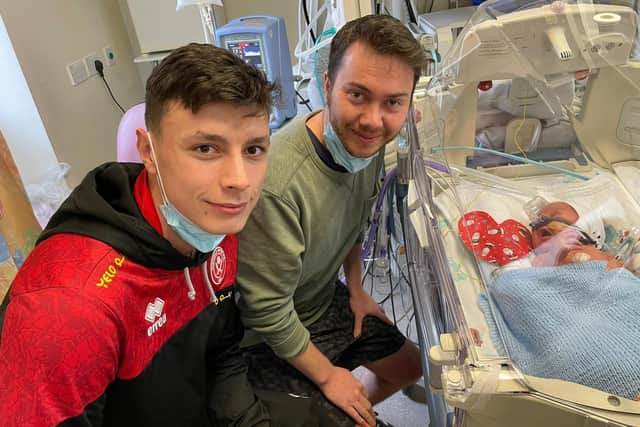 It was a dream come true for Blades fans – as the promotion chasing team’s stars turned out to visit them in hospital in Sheffield. Left to Right SUFC Player Anel Ahmedhodzic, Dad Robbie and Baby son Sam
