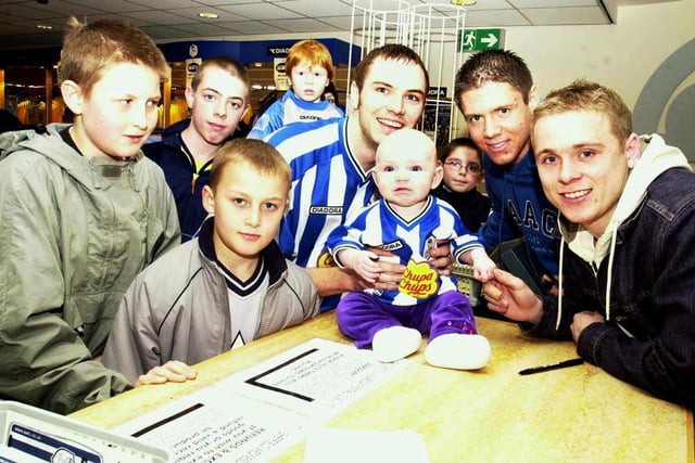 Del Geary and Leigh Bromby signing autograph's at Hillsborough in 2002 with four month old Megan and her father Michael Mellor - looking on are some of the Wednesday fans.