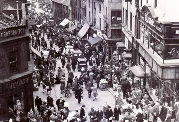 Dixon Lane, Sheffield in 1950 - The caption on this old photograph reads "There's something lively and "matey" about a shopping crowd.  Let's keep the town alive a little later, on Saturdays at any rate".