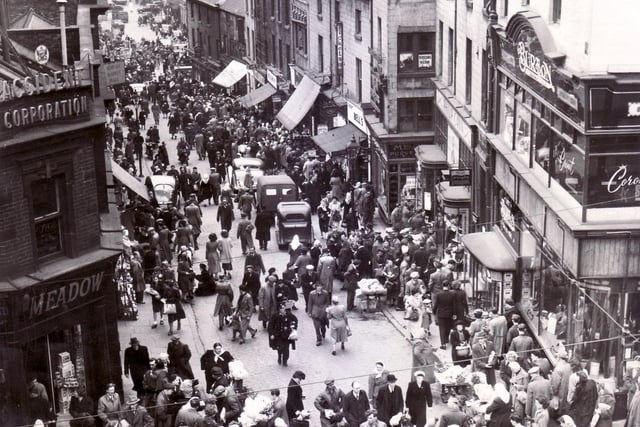 Dixon Lane, Sheffield in 1950 - The caption on this old photograph reads "There's something lively and "matey" about a shopping crowd.  Let's keep the town alive a little later, on Saturdays at any rate".