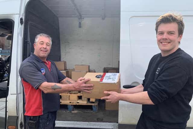 George Brook, Triple Point sales manager, left, hands a beer order to a courier.