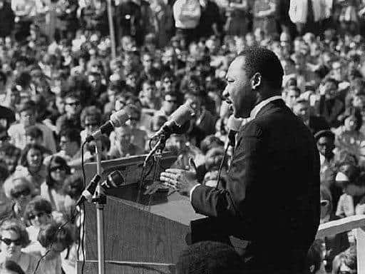 Black civil rights movement leader Rev Dr Martin Luther King speaks to a huge protest